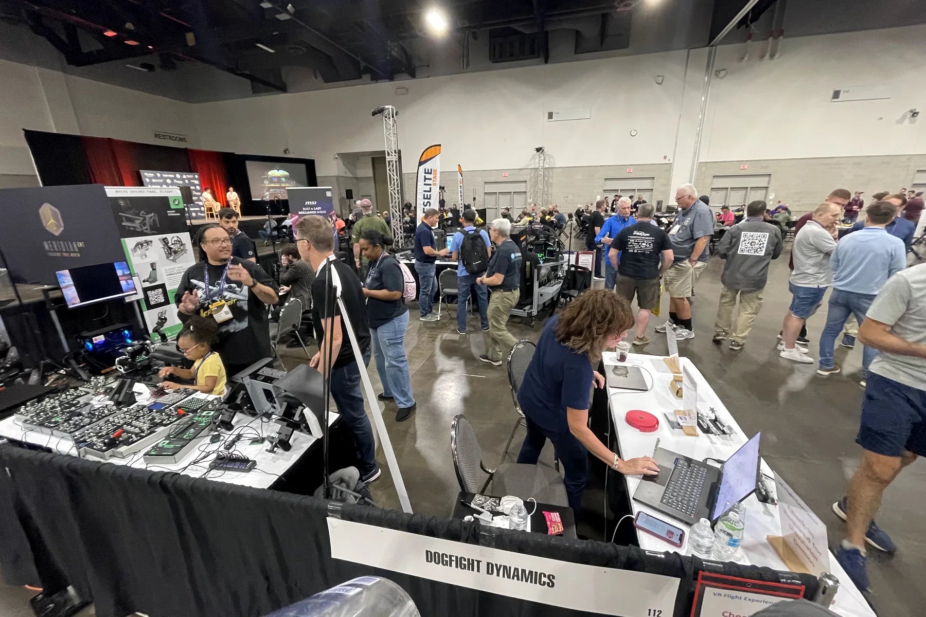 Crowded FlightSimExpo 2025 show floor near the Dogfight Dynamics booth