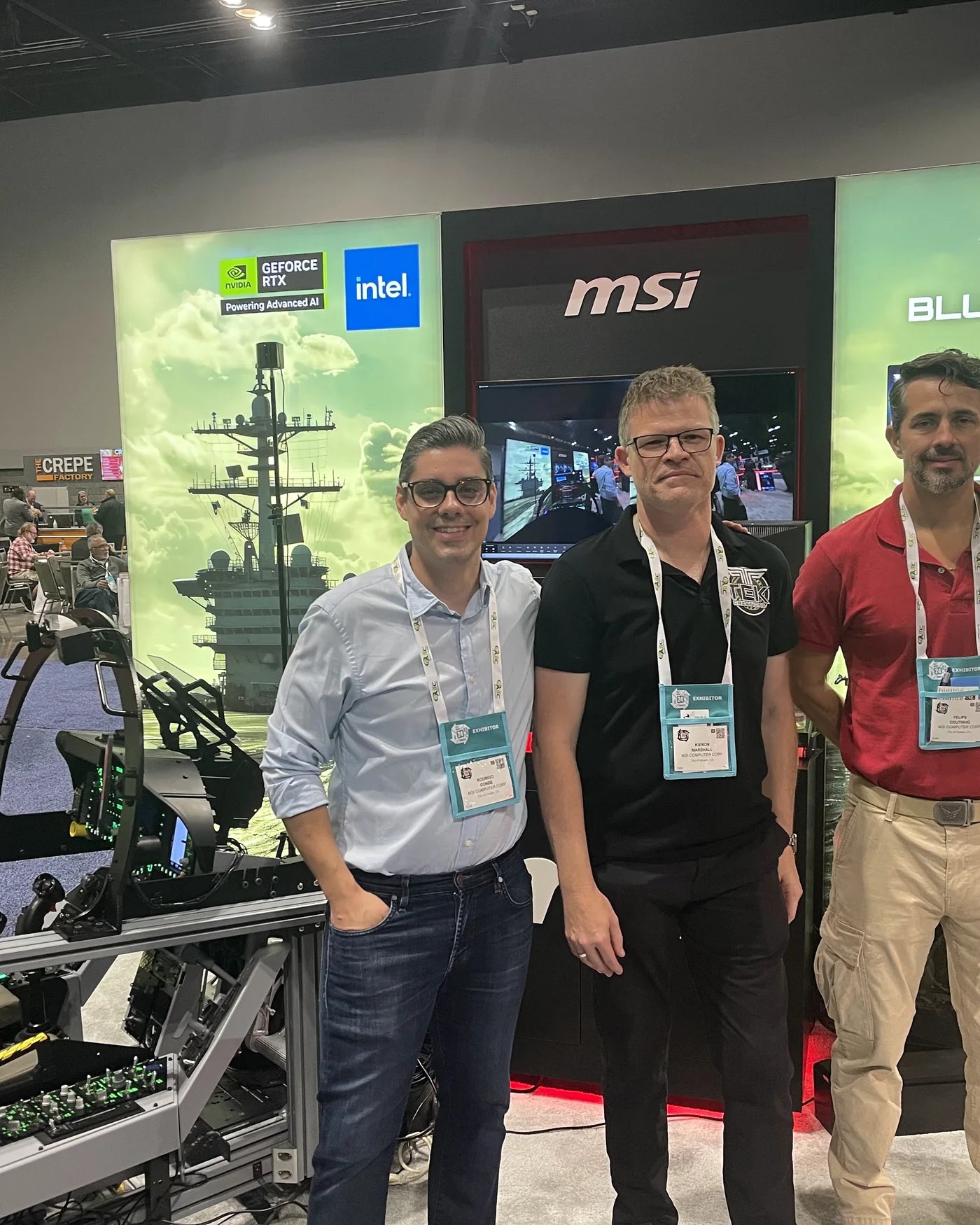 Dogfight Dynamics and MSI team members beside the cockpit at I/ITSEC 2024