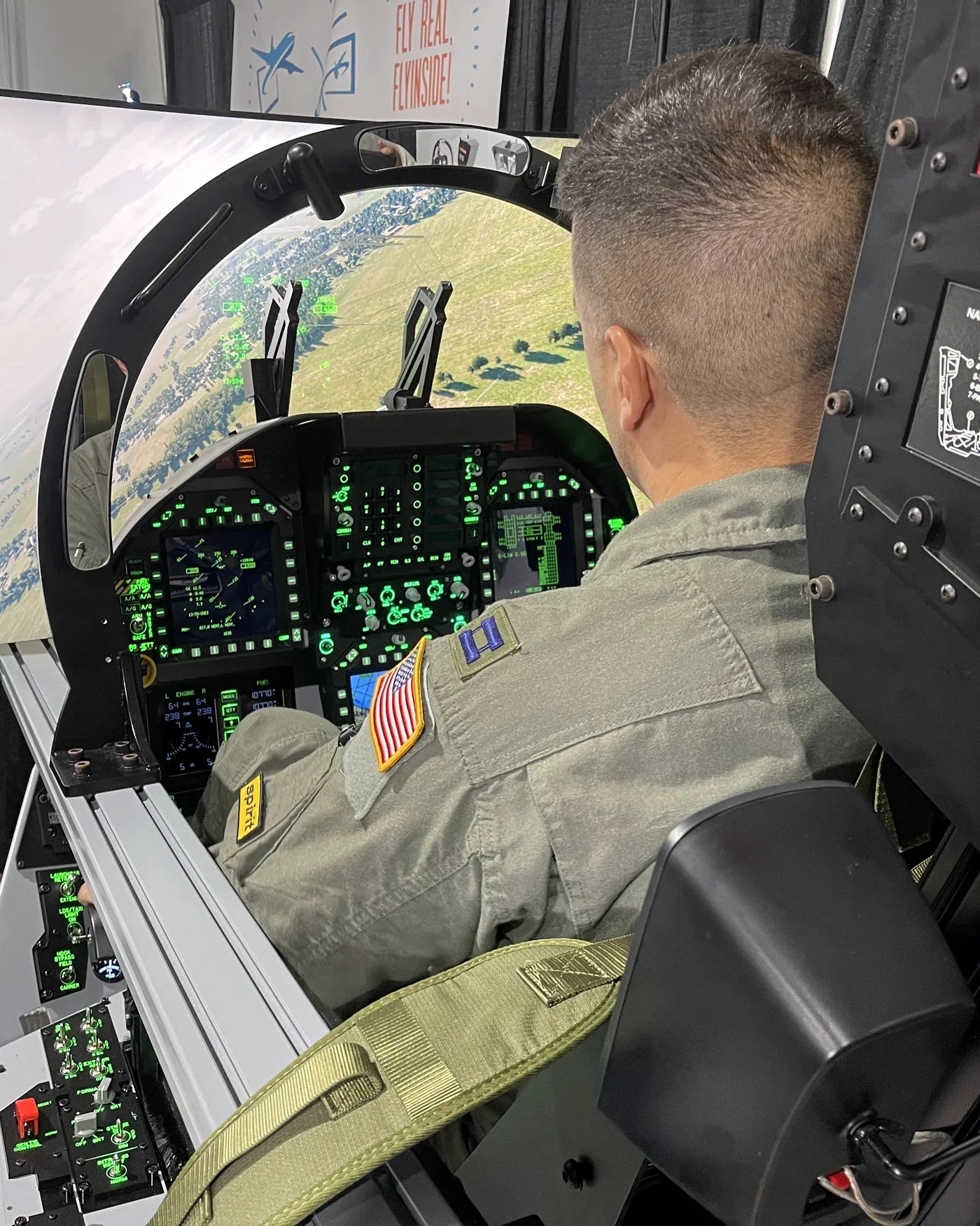 SUN 'n FUN attendee operating the illuminated F/A-18C cockpit simulator