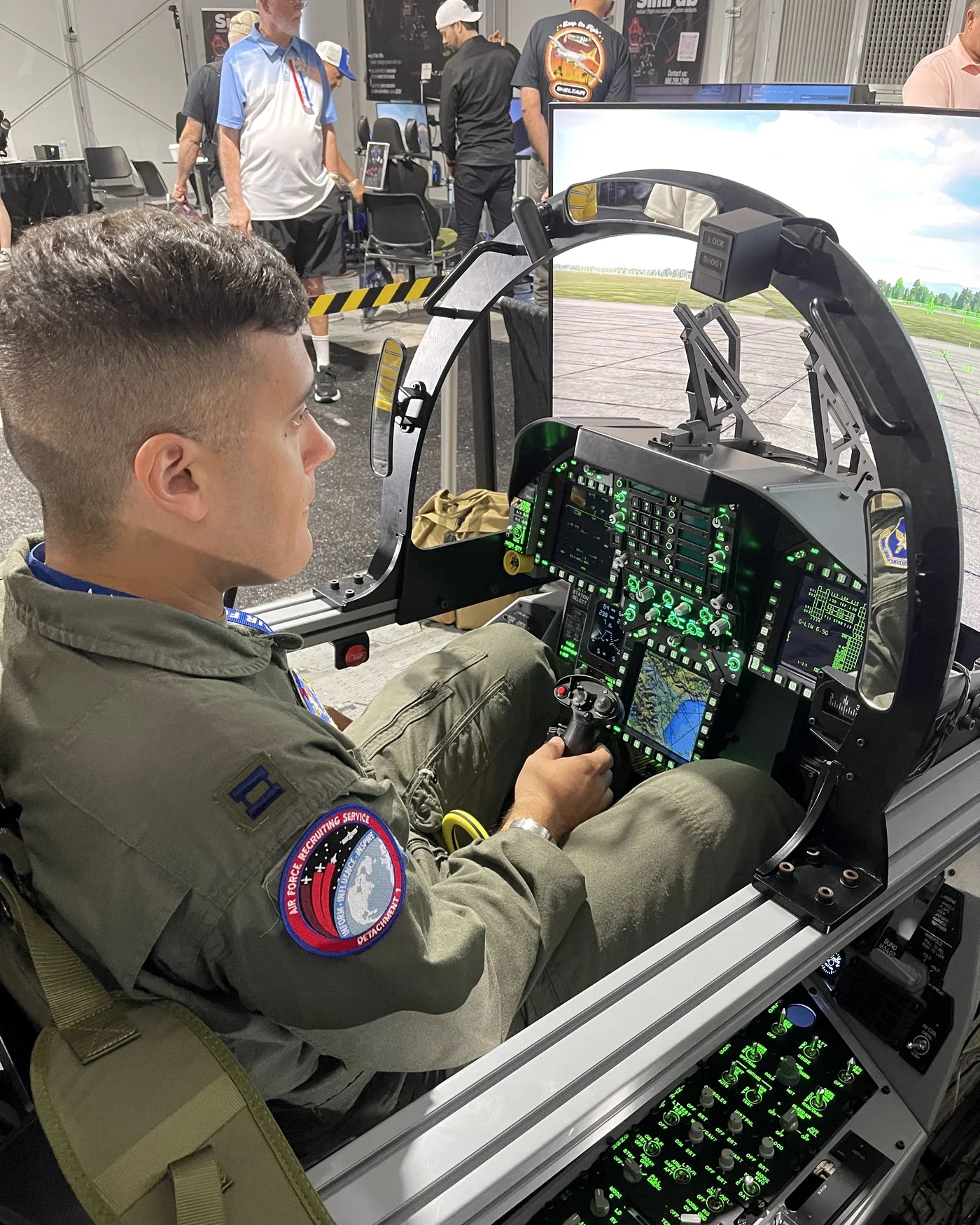 Pilot flying the illuminated Dogfight Dynamics F/A-18C cockpit at SUN 'n FUN